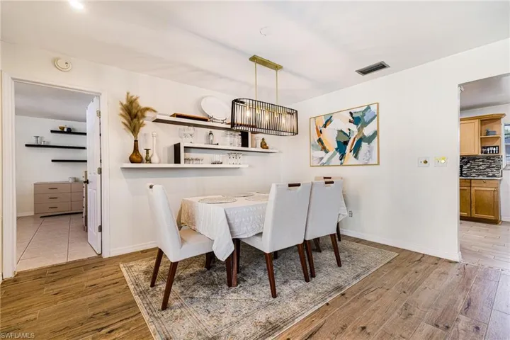 Dining room featuring wood finished floors and baseboards