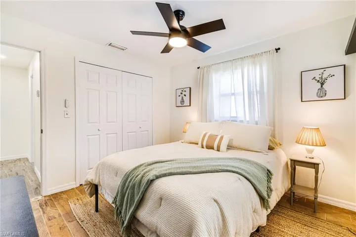 Bedroom featuring a closet, light wood finished floors, and ceiling fan