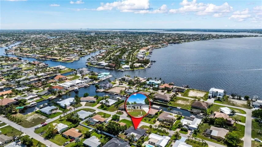 Aerial view of property and surrounding area featuring nearby suburban area