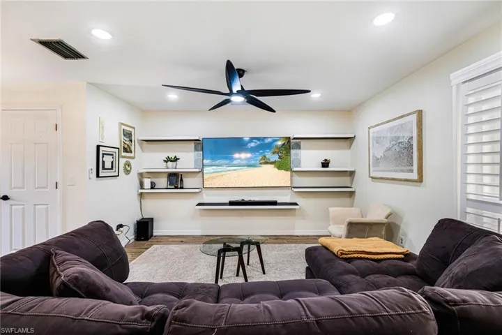Living room featuring ceiling fan, wood finished floors, and recessed lighting