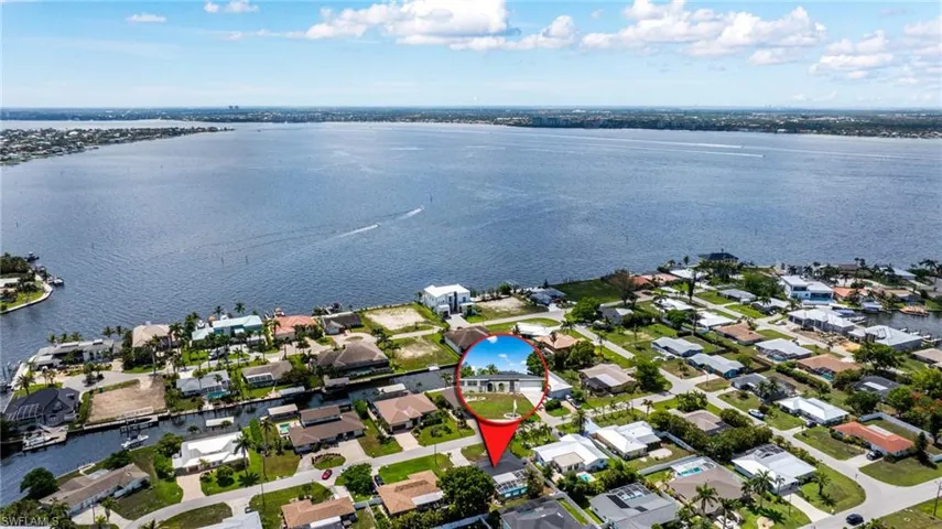Aerial overview of property's location featuring a large body of water and nearby suburban area