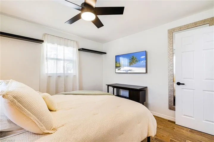 Bedroom featuring wood finished floors and a ceiling fan