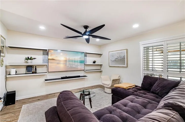 Living room featuring a ceiling fan, recessed lighting, and wood finished floors