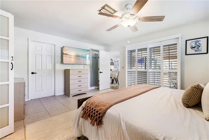 Bedroom featuring light tile patterned floors and ceiling fan