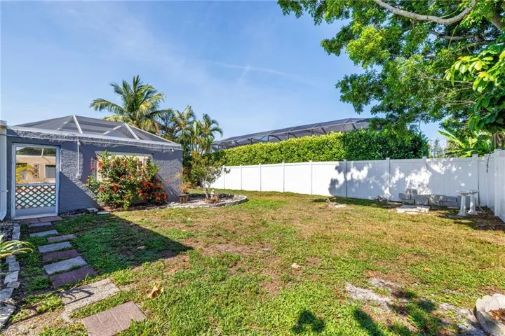 Fenced backyard with a lanai