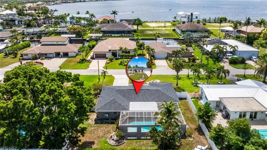 Aerial perspective of suburban area with a nearby body of water