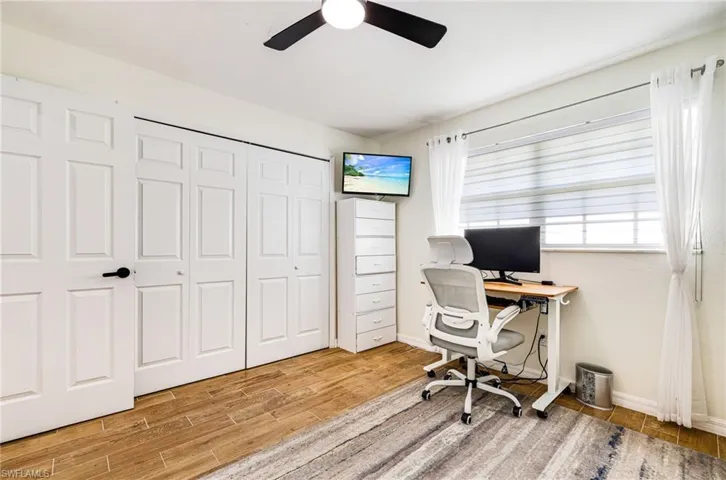 Office area featuring light wood-style flooring and a ceiling fan