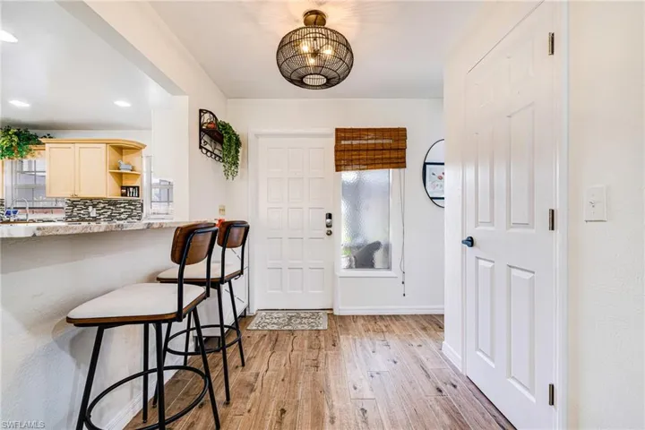 Entrance foyer featuring light wood-style floors, recessed lighting, and a chandelier