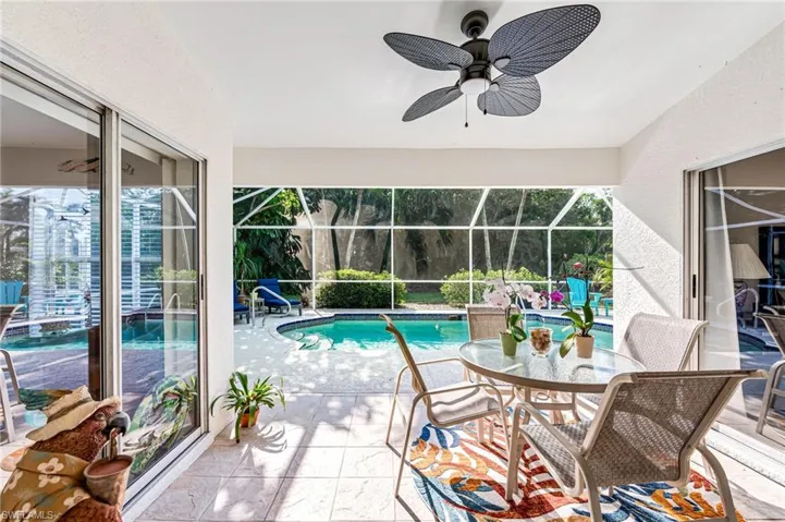 Pool with ceiling fan, a lanai, and a patio area