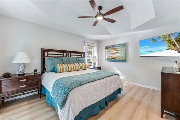 Master Bedroom with a ceiling fan, a tray ceiling