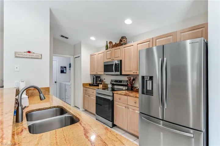 View of kitchen and into the  laundry room