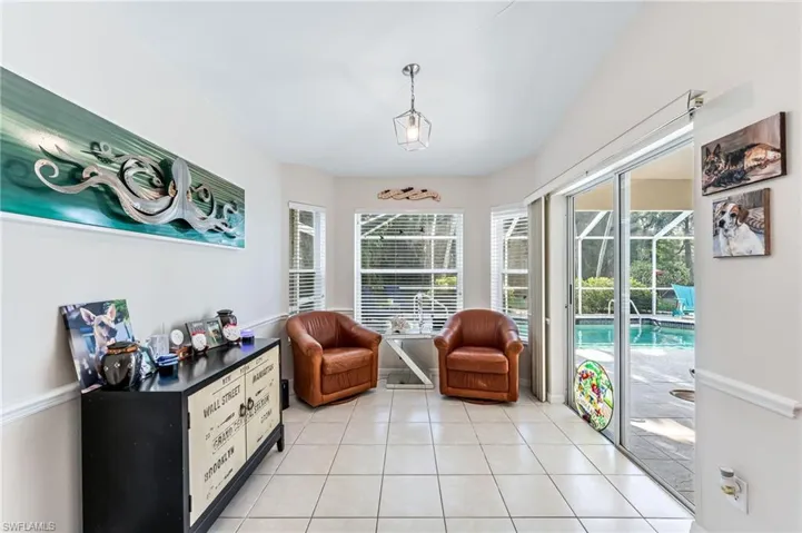 Eat in kitchen area, set up as a sitting room with doors to lanai/pool area