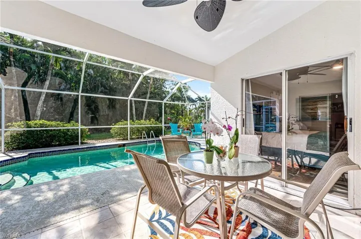 pool featuring a patio, a lanai, and a ceiling fan