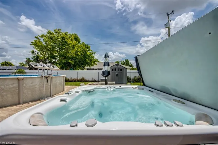 View of pool with a storage shed and a swimming pool
