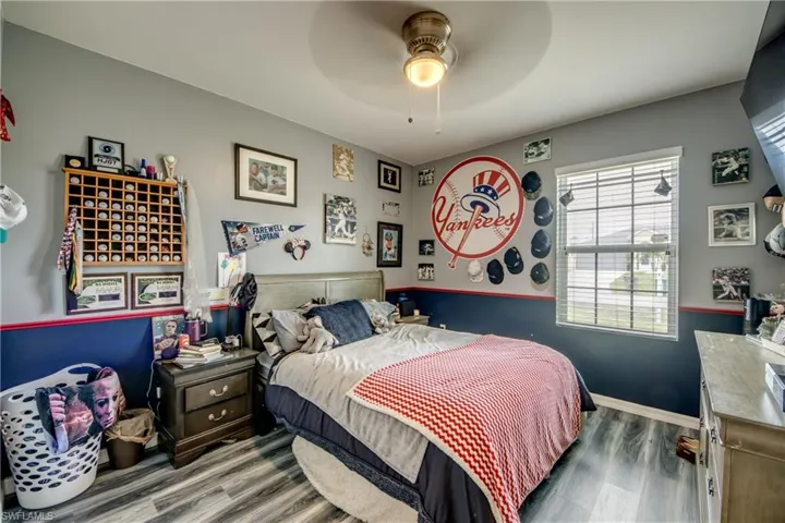 Bedroom featuring wood finished floors and ceiling fan
