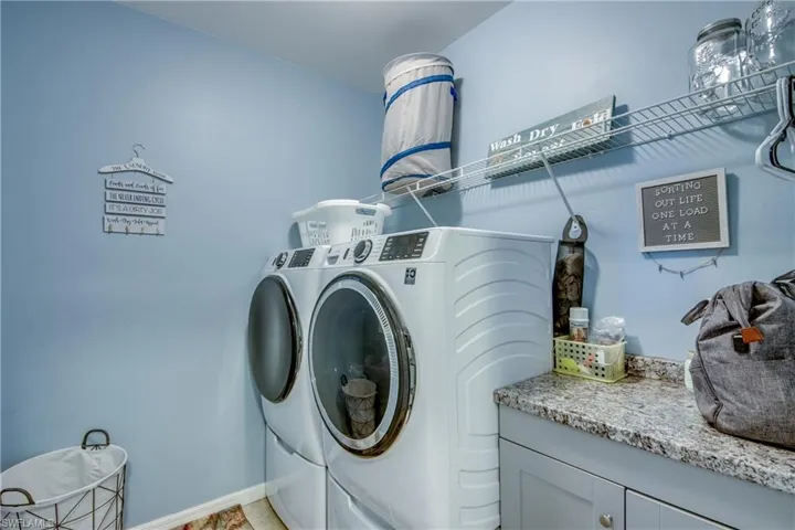 Laundry room with washer and dryer and baseboards