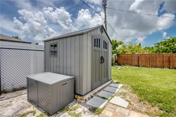 View of shed with a fenced backyard