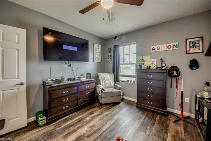 Bedroom featuring wood finished floors and a ceiling fan