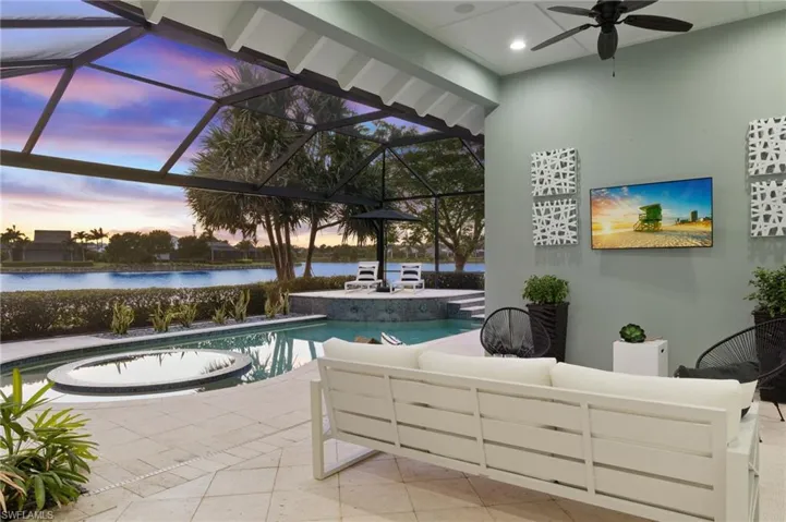 Pool at dusk featuring ceiling fan
