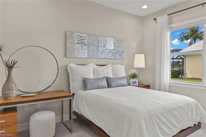 Carpeted bedroom featuring multiple windows