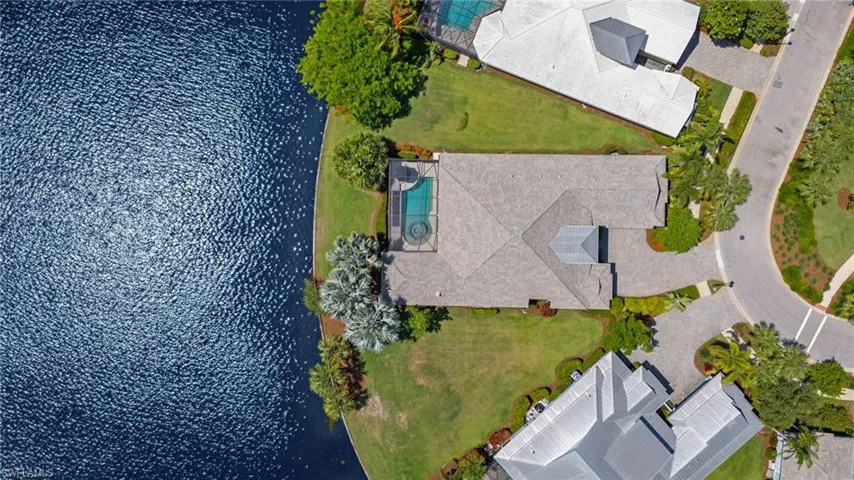 Birds eye view of property with a water view