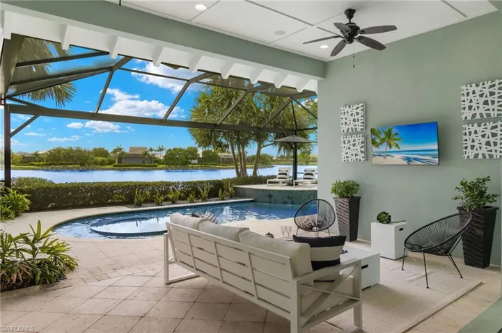 View of swimming pool with a patio, an outdoor hangout area, and ceiling fan