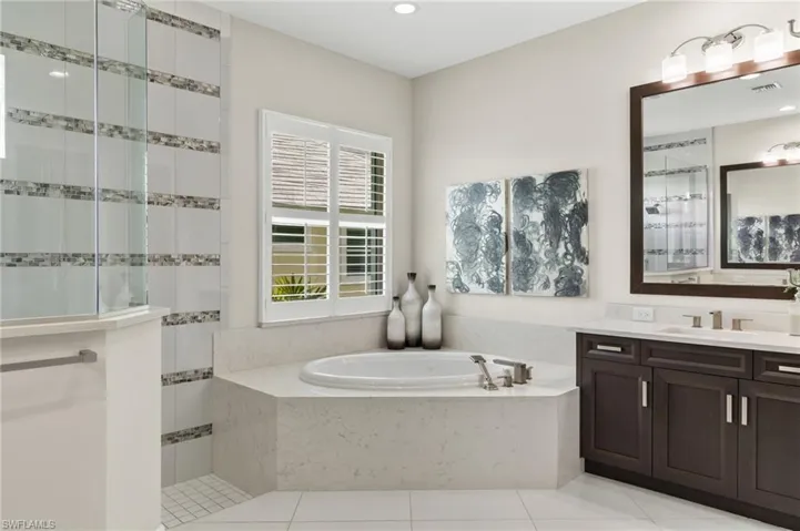 Bathroom with vanity, plus walk in shower, and tile patterned floors