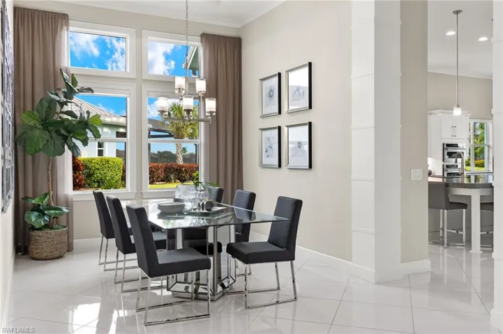 Tiled dining room featuring ornamental molding
