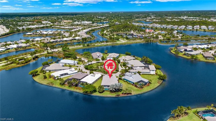 Birds eye view of property with a water view