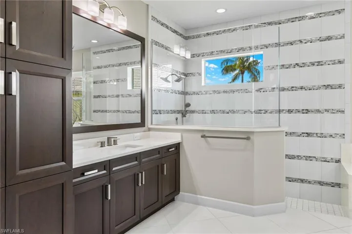 Bathroom featuring tile patterned floors and vanity