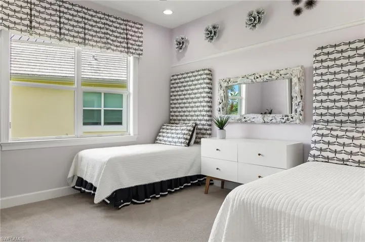 Bedroom with multiple windows and carpet floors
