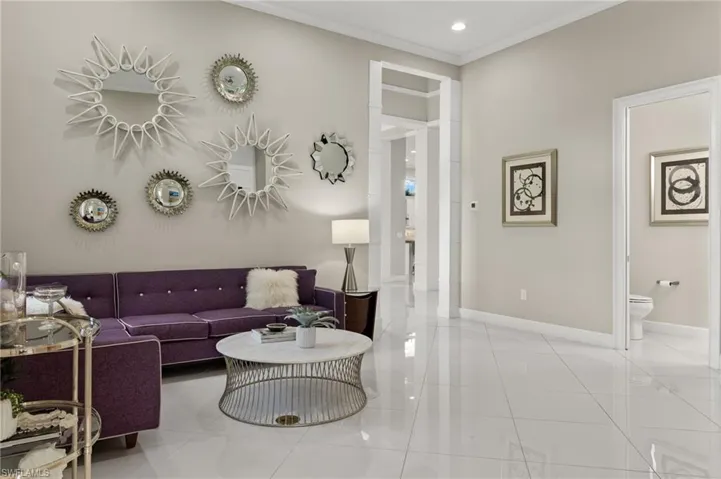 Living room featuring tile patterned floors and ornamental molding