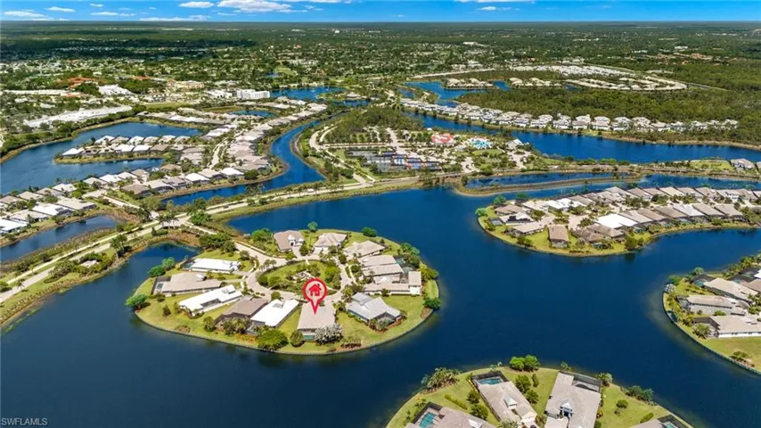 Birds eye view of property with a water view