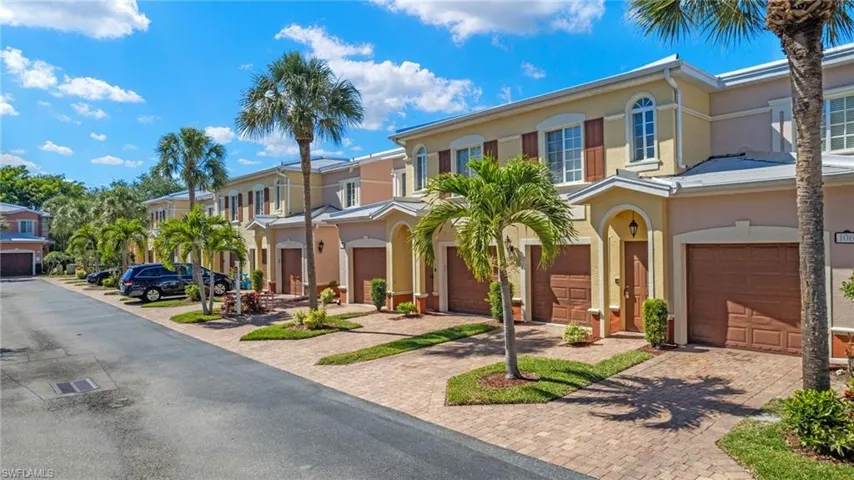 Mediterranean / spanish-style home featuring stucco siding, decorative driveway, a garage, and a residential view