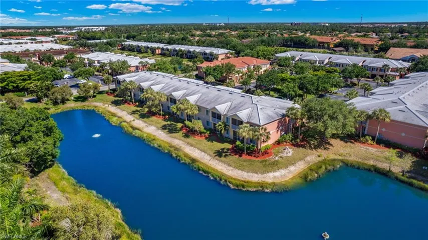 Drone / aerial view of a large body of water and apartment complex