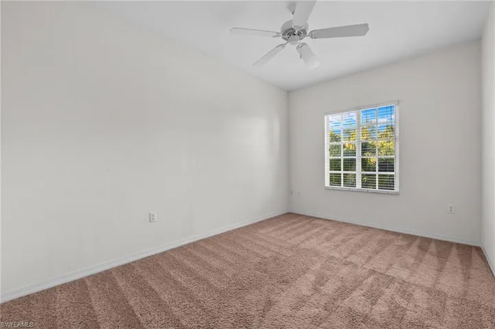 Unfurnished room with carpet and ceiling fan