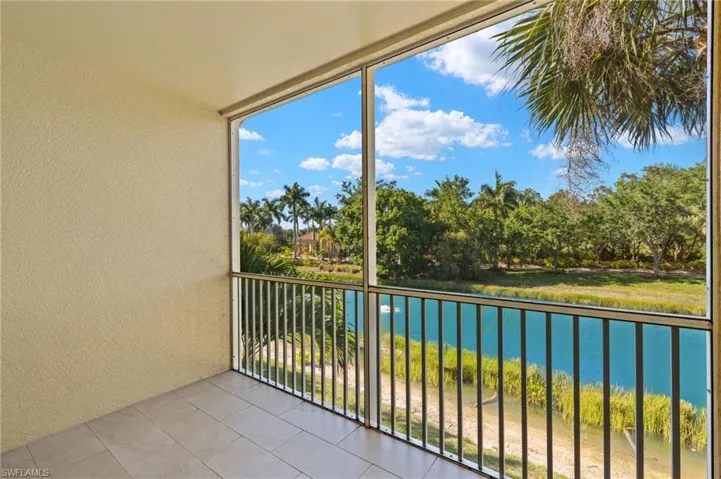 Balcony with a water view and a sunroom