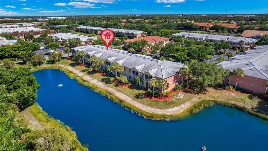 Drone / aerial view of a large body of water and apartment complex