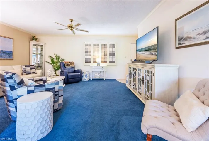 Looking from dining area into living room.  On far left is a sofabed.  Far right is foyer & into guest bath--with large closet.