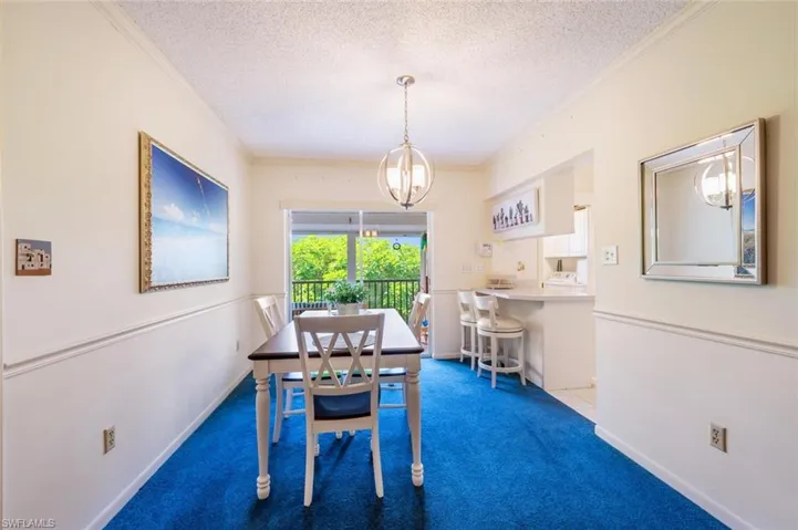 Dining area looking out to lanai--kitchen on right .