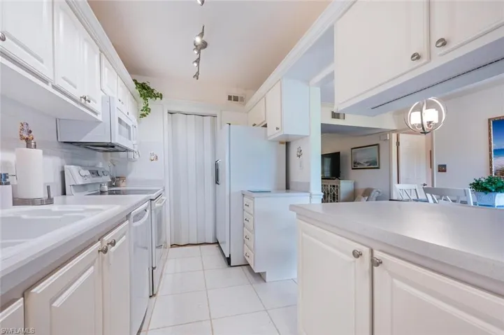 Efficient galley kitchen looking towards walk-in pantry-lots of storage!