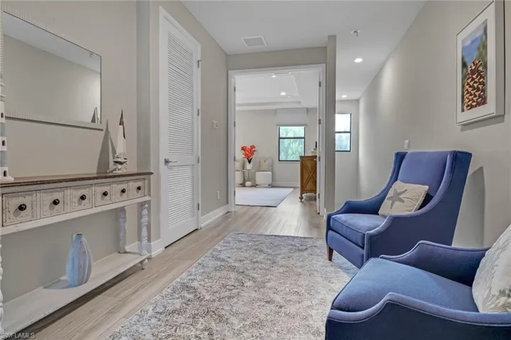Living area featuring light wood-type flooring and recessed lighting