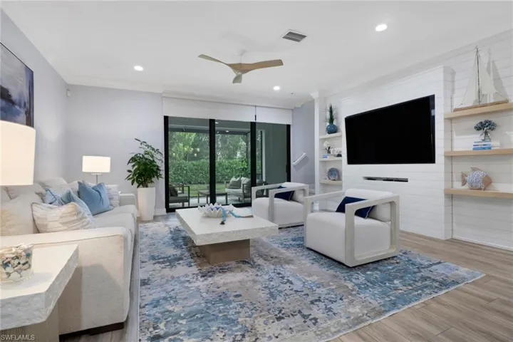 Living room featuring wood finished floors, recessed lighting, a ceiling fan, and ornamental molding