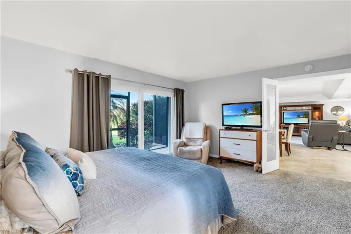 Bedroom with light carpet and access to outside