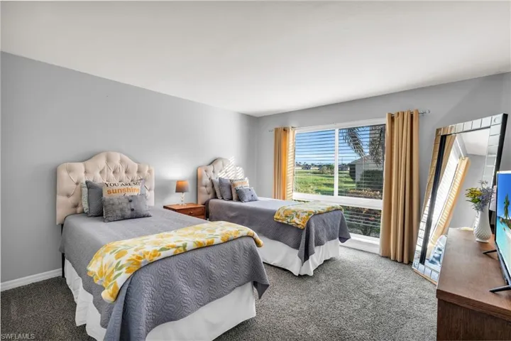 Bedroom featuring dark carpet