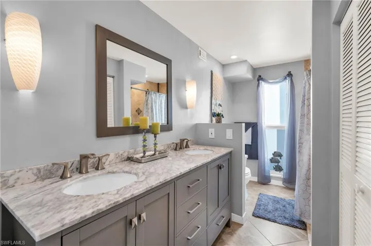 Bathroom with tile patterned flooring, vanity, and toilet