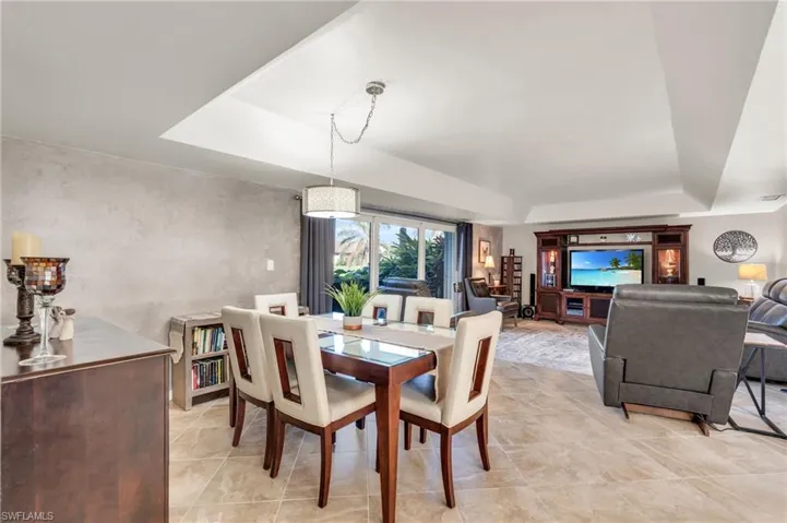 Dining space featuring a raised ceiling