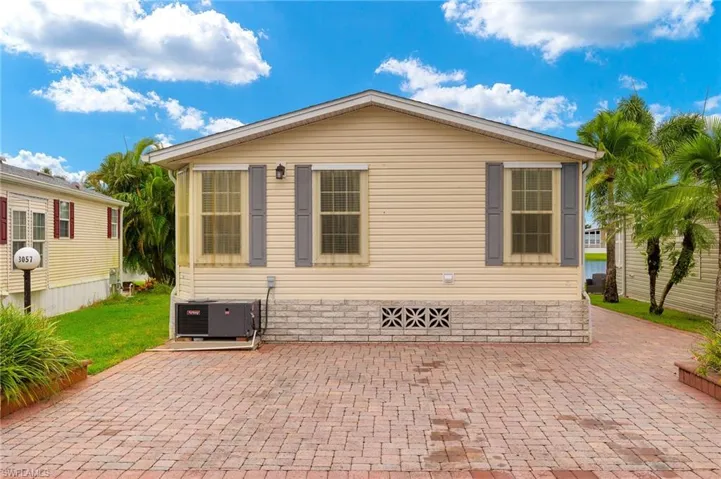 Back of house with central air condition unit and a patio area