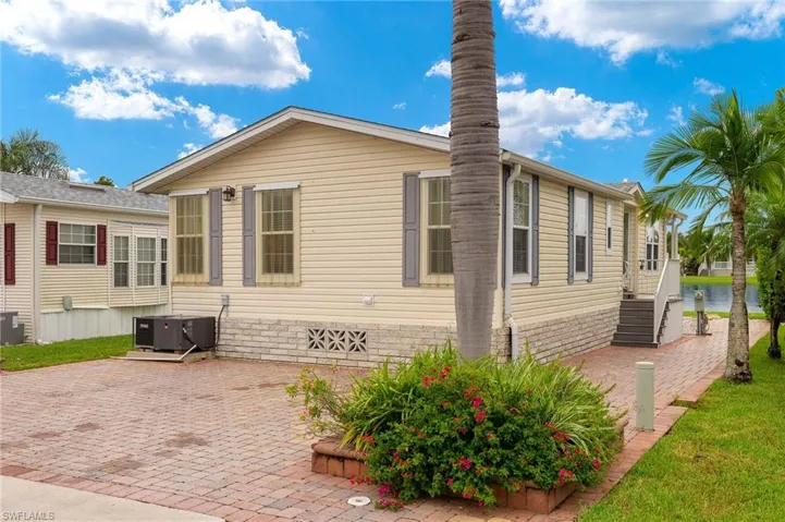 View of side of home with central AC and a patio area