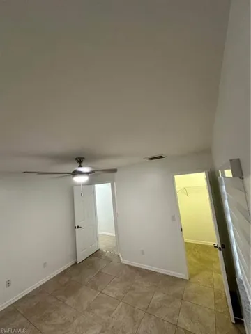 Spare room with light tile patterned floors and a ceiling fan